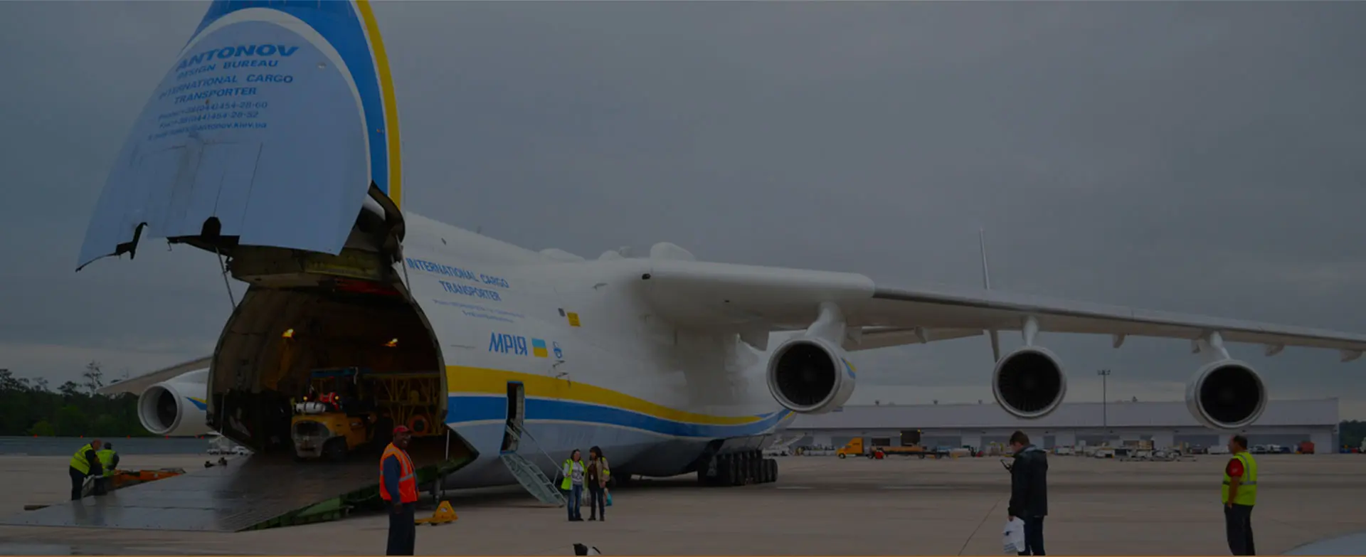 Logistics and transportation of Container Cargo ship and Cargo plane with working crane bridge in shipyard at sunrise, logistic import export and transport industry background